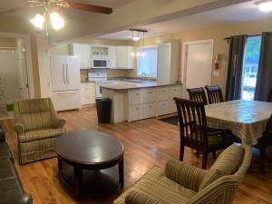 a kitchen and living room with a table and chairs at Wu Wu's Cabins in Wasaga Beach
