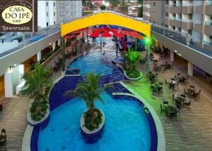 an overhead view of a large swimming pool in a shopping mall at Apto do Veloso no Resort in Olímpia
