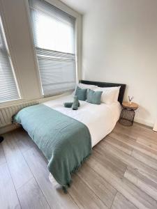 a large bed in a room with two windows at King's Cross in London