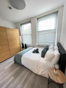 a bedroom with a large bed and a table at King's Cross in London