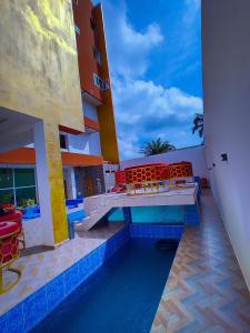 a balcony of a building with red chairs on it at TOUR EIFFEL HÔTEL in Porto-Novo