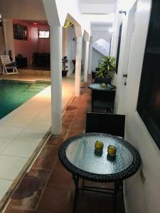 a table and chairs in a hallway with a pool at HCeas Villas Compound in Bon Accord