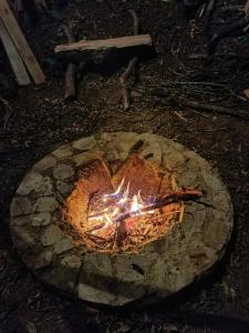 a fire pit in the ground with flames in it at Chalé do Mirante do Itacolomi in Ouro Preto +5 photos