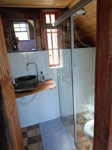 a bathroom with a shower and a toilet at Chalé do Mirante do Itacolomi in Ouro Preto