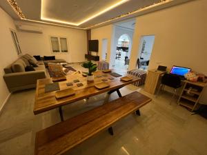 a living room with a wooden table and a couch at VillaLina Haut Standing Djerba in Ajim