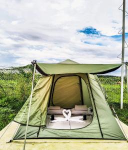 a green tent with a symbol in the middle at Camp Palo Bandera in Calatagan