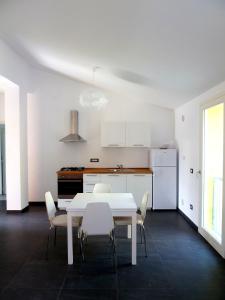 a white dining room with a white table and chairs at Al Molino delle Ghiare in Levanto +33 photos