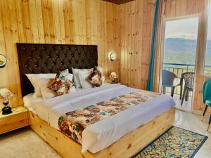 a bedroom with a large bed with a balcony at Nature Heaven Lodge, Mussoorie in Mussoorie