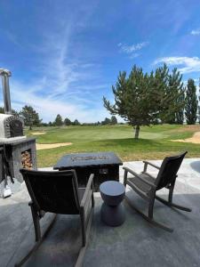 a patio with two chairs and a table and a grill at Moses Lake Golf Retreat @ Resorts At Moses Pointe in Moses Lake