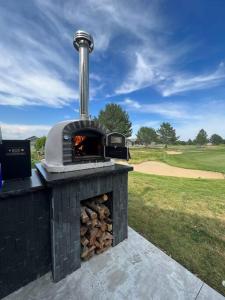 a brick oven with a fire place in a field at Moses Lake Golf Retreat @ Resorts At Moses Pointe in Moses Lake