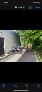 a picture of a patio with two tables and a fence at Harry’s place in Mullingar