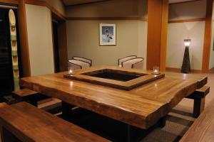 a conference room with a wooden table and chairs at Hakuba Onsen Ryokan Shirouma-so in Hakuba