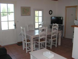 uma cozinha e sala de jantar com mesa e cadeiras em Maison Noirmoutier-en-l'Île, 4 pièces, 6 personnes - FR-1-224B-201 em Noirmoutier-en-l'lle
