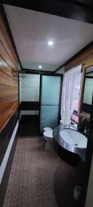 a bathroom with a tub and a toilet and a sink at Malbros guest house in Baguio