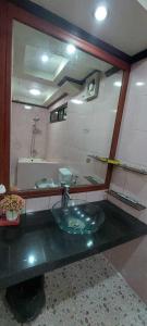 a bathroom with a sink and a mirror at Malbros guest house in Baguio