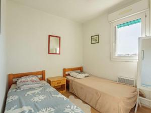 1 Schlafzimmer mit 2 Betten und einem Fenster in der Unterkunft Appartement Anglet, 2 pièces, 4 personnes - FR-1-3-592 in Anglet