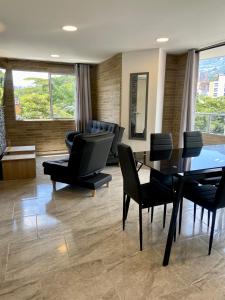 a living room with black chairs and a table at Apartamento con Excelente Ubicación en Envigado in Envigado