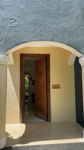 a doorway to a house with a blue wall at Romantic Mediterranean beach house in Dar es Salaam