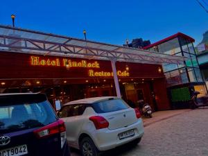 a white car parked in front of a hotelruck restaurant at Hotel Pine Rock Mountain View, Mussoorie in Mussoorie