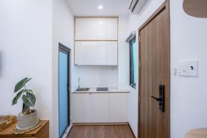 a small kitchen with a sink and a door at Lamy's House Cần Thơ in Can Tho +36 photos