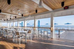 a restaurant with tables and chairs and a view of the ocean at Foxy Palmer! 3 bedroom 2 bath in Perdido Golf Resort in Pensacola