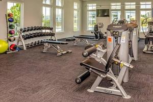 a gym with several treadmills and exercise bikes at Foxy Palmer! 3 bedroom 2 bath in Perdido Golf Resort in Pensacola