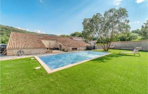 a yard with a swimming pool in front of a house at Beautiful Home In Pardailhan With Wifi in Pardailhan