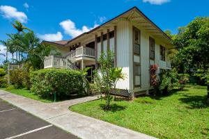 a large white house with a yard at Spacious Princeville studio in Princeville