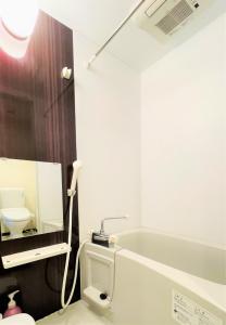 a bathroom with a toilet and a sink and a mirror at Credo Maison Kamakura - Vacation STAY 10394 in Kamakura
