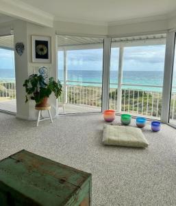 a living room with a view of the ocean at Arcadia Beachfront Retreat in Mandurah