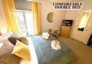 a bedroom with a bed with a tray of food on it at Cute and cosy studio in a Fantastic Location! BISHOPS STORTFORD in Bishops Stortford
