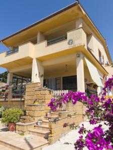 a house with purple flowers in front of it at Ulivi di Cleo in Realmonte