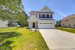 a house with a driveway and a garage at Holly Ridge Vacation Rental about 5 Mi to Beach in Holly Ridge