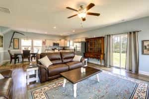 a living room with a couch and a table at Holly Ridge Vacation Rental about 5 Mi to Beach in Holly Ridge