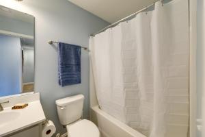 a bathroom with a white shower curtain and a toilet at Holly Ridge Vacation Rental about 5 Mi to Beach in Holly Ridge +16 photos