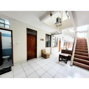 a living room with a staircase and a stair case at Teratai Residence in Bandung