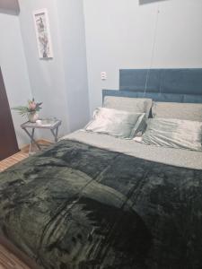 a bedroom with a bed with a rug on it at Apartament Blisko Natury in Olsztyn