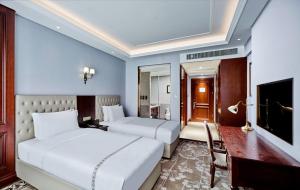 Postel nebo postele na pokoji v ubytování Guangming CIMC Executive Hotel Shenzhen