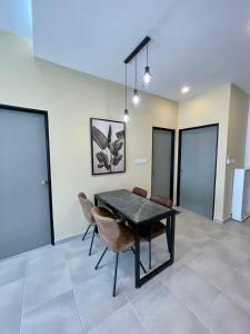 a dining room with a black table and chairs at Sandakan Homestay Coastal Serenity 山海绿栖 in Sandakan