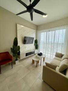 a living room with a couch and a ceiling fan at Sandakan Homestay Coastal Serenity 山海绿栖 in Sandakan