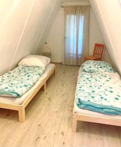 two beds in a room with a attic at Finnhütte Strandbad Adria in Dessau
