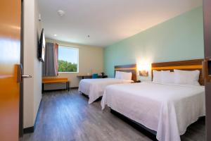 Cette chambre comprend 2 lits et une fenêtre. dans l'établissement SPOT X Hotel Orlando Intl Dr by The Red Collection, à Orlando