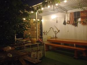 a patio with a wooden bench and a table at Homestay Da Blah in Da Ðeum (2)