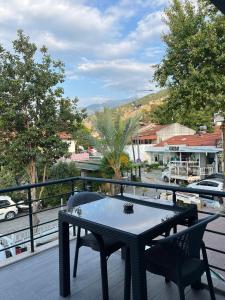 een tafel en stoelen op een balkon met uitzicht bij Moni Homes in Fethiye