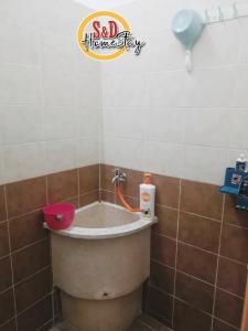 a bath tub in a bathroom with a faucet at Homestay Taman Lagenda Padang Serai in Padang Serai