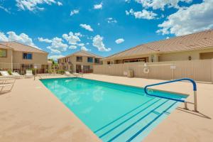 a swimming pool in front of a house at Mesquite Vacation Rental Condo with Resort Amenities in Mesquite