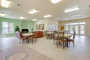 a dining room with tables and chairs and a fireplace at Mesquite Vacation Rental Condo with Resort Amenities in Mesquite
