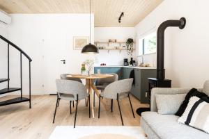 a kitchen and living room with a table and chairs at Babia Rest - całoroczny domek z balią z jacuzzi in Zawoja