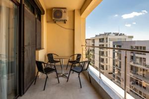 a balcony with chairs and a table on a balcony at SnS Apartament Regal in Mamaia