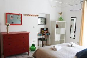 a bedroom with a bed and a dresser and a mirror at Casa masseria dell'800 Gargano. Le Mignole in Monte SantʼAngelo